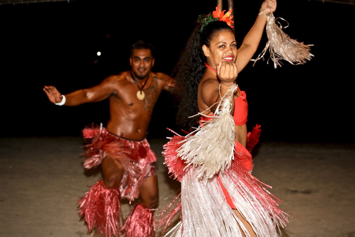 Fijian cultural dancers performing at night